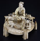 A Japanese ivory okimono of a man and two boys, signed Shomi, Meiji period the man holding a fan and
