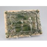 A Chinese green glazed pottery rectangular tile, moulded in relief with a Chinese scholar, attendant