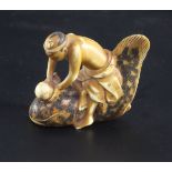 A Japanese ivory netsuke of a man riding a cat fish, 19th century, signed Shunkosai, the man holding