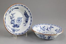 A pair of Chinese blue and white bowls, early 18th century, each painted with flowers and rockwork