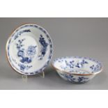 A pair of Chinese blue and white bowls, early 18th century, each painted with flowers and rockwork