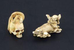 Two Japanese ivory netsuke, Meiji period, the first carved as two huntsmen battling with a boar, two