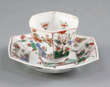 A Chinese famille verte 'G mark' tea bowl and saucer, Kangxi period, of hexagonal shape painted with