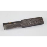 A Chinese export tortoiseshell fold out comb, 19th century, carved in relief with figures amid