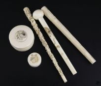 Three Japanese ivory parasol handles and two small boxes and covers, early 20th century, the boxes