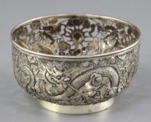 A Chinese silver 'dragon' bowl, late 19th century, embossed and pierced with three dragons amid
