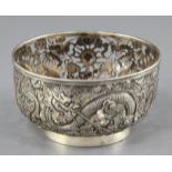 A Chinese silver 'dragon' bowl, late 19th century, embossed and pierced with three dragons amid