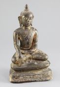 A Burmese gilt lacquered bronze seated figure of Buddha, Shan period, 18th century, with remnants of