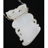 A Chinese archaistic white jade pendant, 19th / 20th century, with white metal mount and chain (26cm