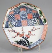 A Japanese Kakiemon style octagonal dish, late 19th/early 20th century, painted with prunus and a