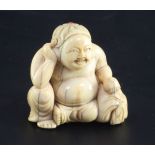 A Japanese ivory seated figure of Hotei, 18th / 19th century, with braided hair inset with coral,