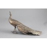 A Japanese silvered copper-bronze figure of a peacock, Meiji period, standing with its tail feathers