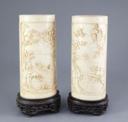 A pair of Chinese ivory vases, early 20th century, each a carved in high relief with farmers and