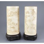 A pair of Chinese ivory vases, early 20th century, each a carved in high relief with farmers and