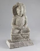 A Gandharan grey schist seated figure of Buddha, 2nd-4th century AD height 25.5cm