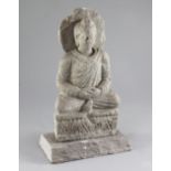 A Gandharan grey schist seated figure of Buddha, 2nd-4th century AD height 25.5cm