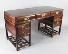 A Chinese hardwood twin pedestal desk, with an arrangement of five drawers around a kneehole, each