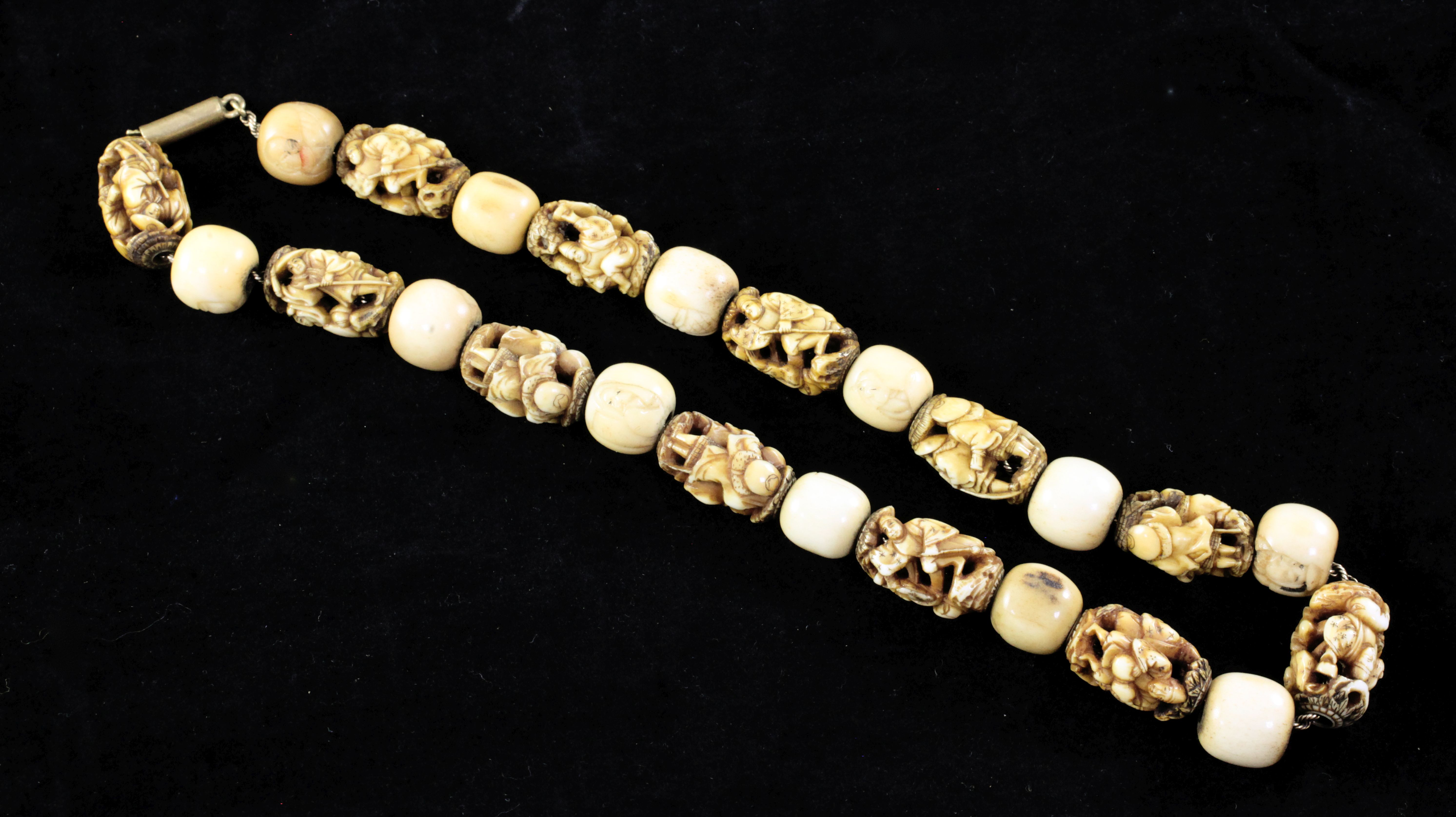 A Japanese ivory and bone Ojime bead necklace, late 19th century, composed of 12 eliptical ivory