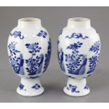A pair of Chinese blue and white lobed ovoid vases, Kangxi period, each painted with panels of