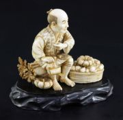 A Japanese ivory okimono of a farmer smoking a pipe, early 20th century, seated amid his crop of