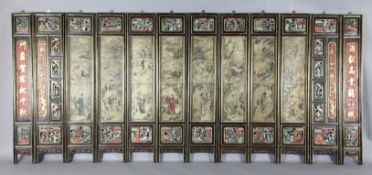 A Chinese 12 panel polychrome and gilt wood screen, 19th century, painted with the eight