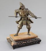 A Japanese parcel gilt bronze figure of a samurai, Meiji period, holding a spear and wearing full