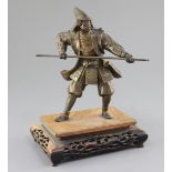 A Japanese parcel gilt bronze figure of a samurai, Meiji period, holding a spear and wearing full