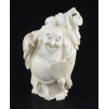 A Japanese ivory figure of Hotei, early 20th century, holding a fan and his sack of wind, engraved