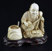 A Japanese ivory okimono of a kneeling musician, early 20th century, with brocade pattern robes
