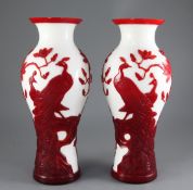 A pair of large Chinese overlaid glass vases, 20th century, in ruby over white glass, decorated with