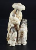 A Japanese walrus ivory okimono of a woman and three children, with engraved robes, two character