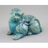 A Japanese turquoise glazed pottery model of a recumbent lion, c.1900, length 18cm