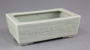 A Chinese celadon glazed narcissus jardiniere, impressed Qianlong mark, 19th century, the frieze