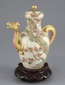 A Japanese Satsuma pottery wine pot, late 19th century, modelled in relief with a prunus tree with a