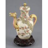 A Japanese Satsuma pottery wine pot, late 19th century, modelled in relief with a prunus tree with a