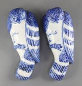 Two Japanese Arita blue and white 'hawk' wall pockets, late 19th century, modelled perched on a