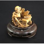 A Japanese ivory netsuke of a skeleton, early 20th century, signed Sei..? seated on a lotus leaf and