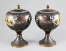 A pair of Chinese cloisonne enamel 'dragon' jars and covers, early 20th century, with black grounds,