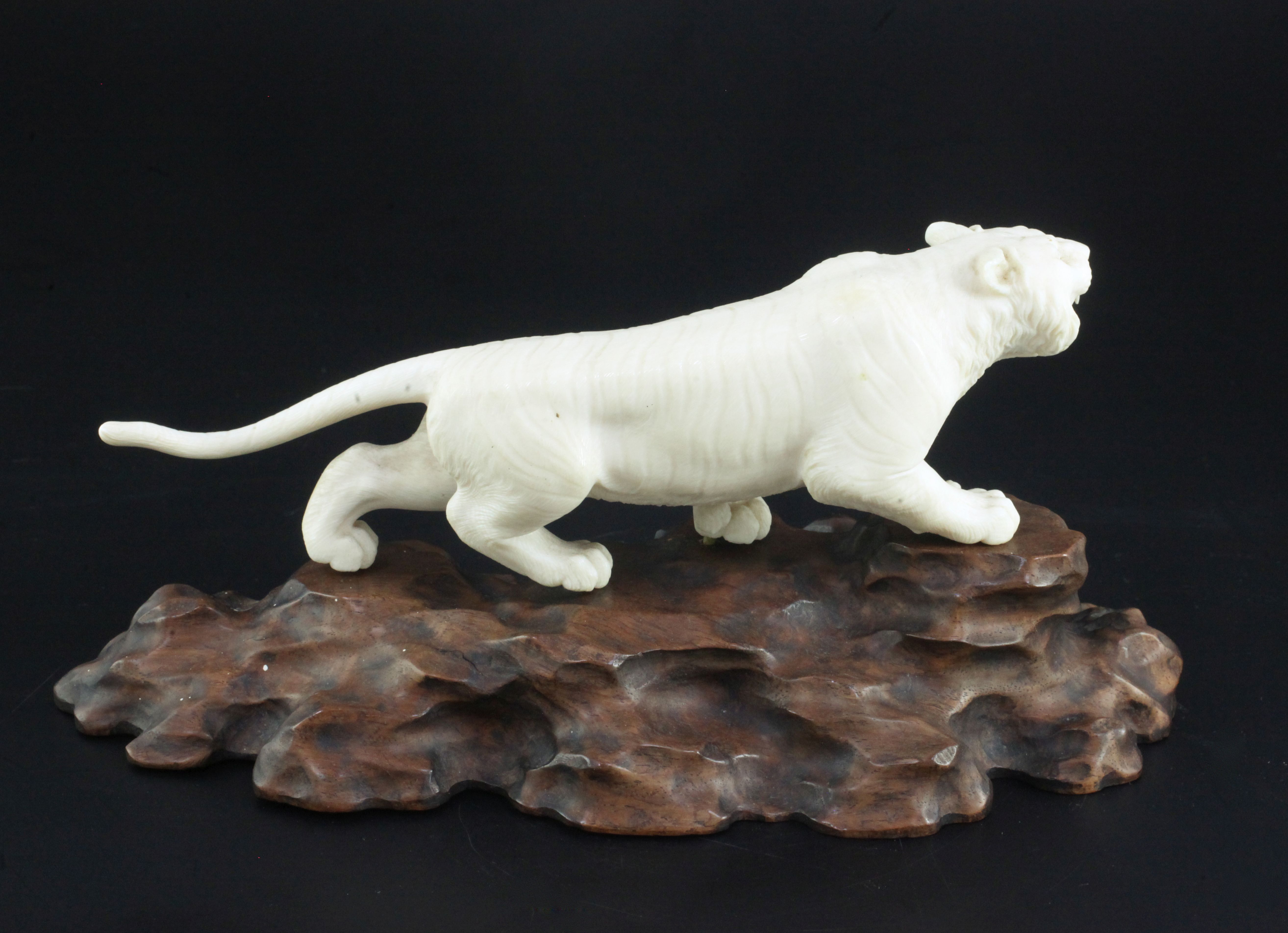 A Japanese ivory figure of a prowling tiger, signed Gyoku..? Meiji period, with glass inset eyes, - Image 2 of 3