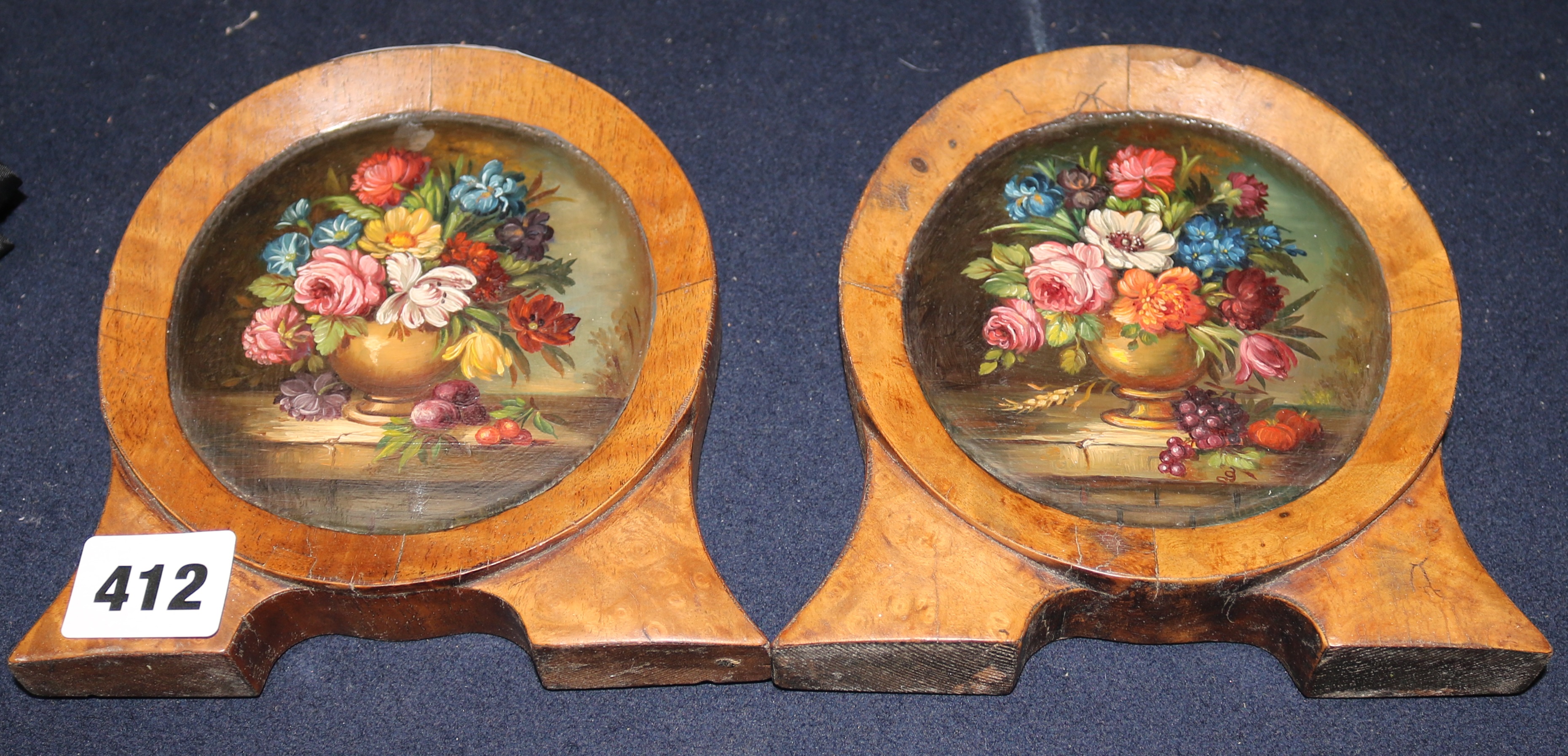 Two small oil on panel roundels of flowers, height overall 14cm