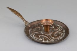 John Pearson. A Newlyn copper chamberstick, c.1899, the well of the dish base embossed and chaste