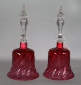 A pair of cranberry glass hand bells