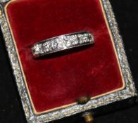 An 18ct white gold and graduated six stone diamond half eternity ring, size