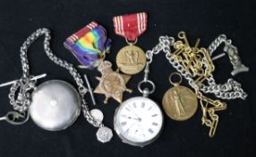 Two silver pocket watches, three medals and a gilt metal albert.