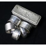 Silver napkin rings and silver topped box