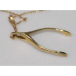 A 9ct gold wishbone pendant, on fine gold chain.