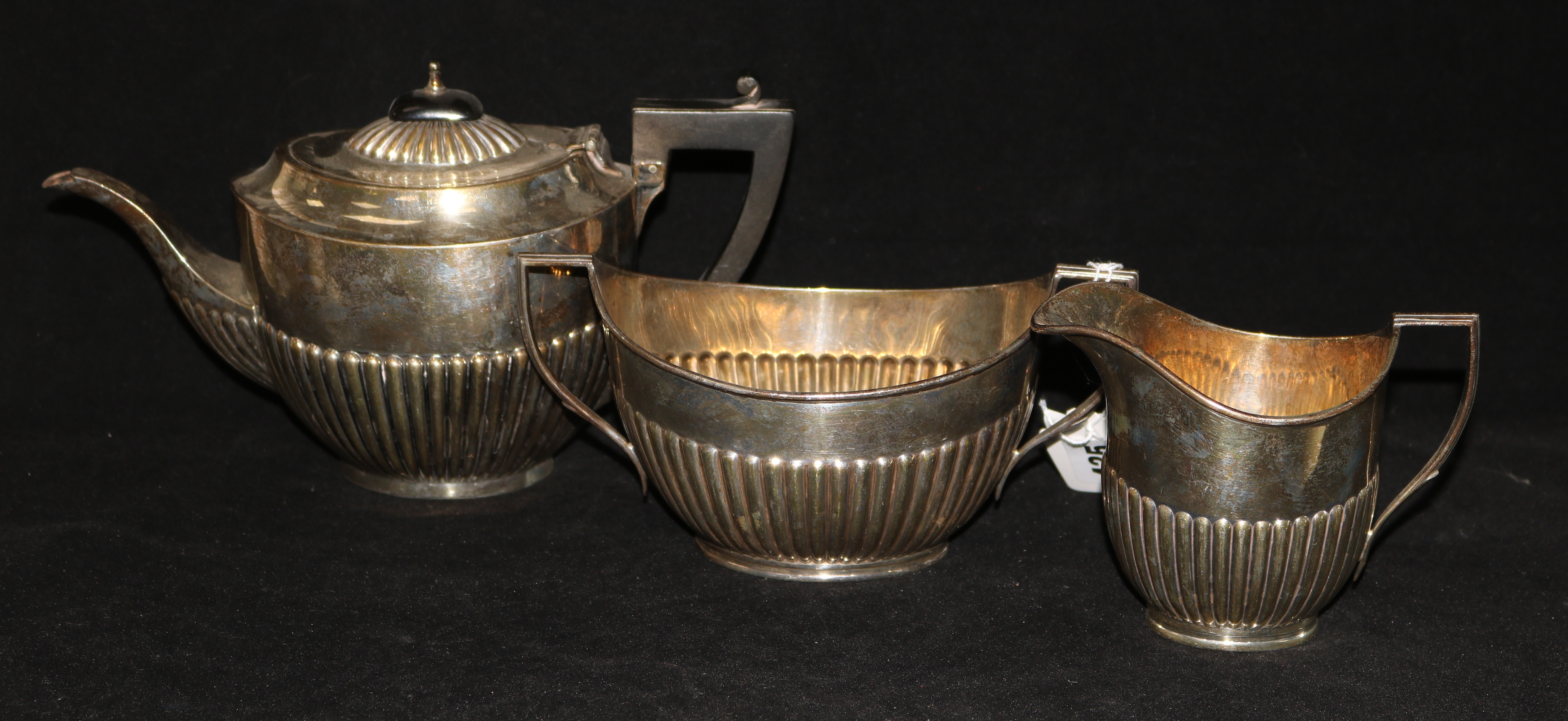 An early 20th century matched three piece silver tea set, gross 20 oz.