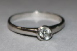 A platinum and solitaire diamond ring. size M.