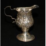 A George III silver cream jug with later decoration, 4in.