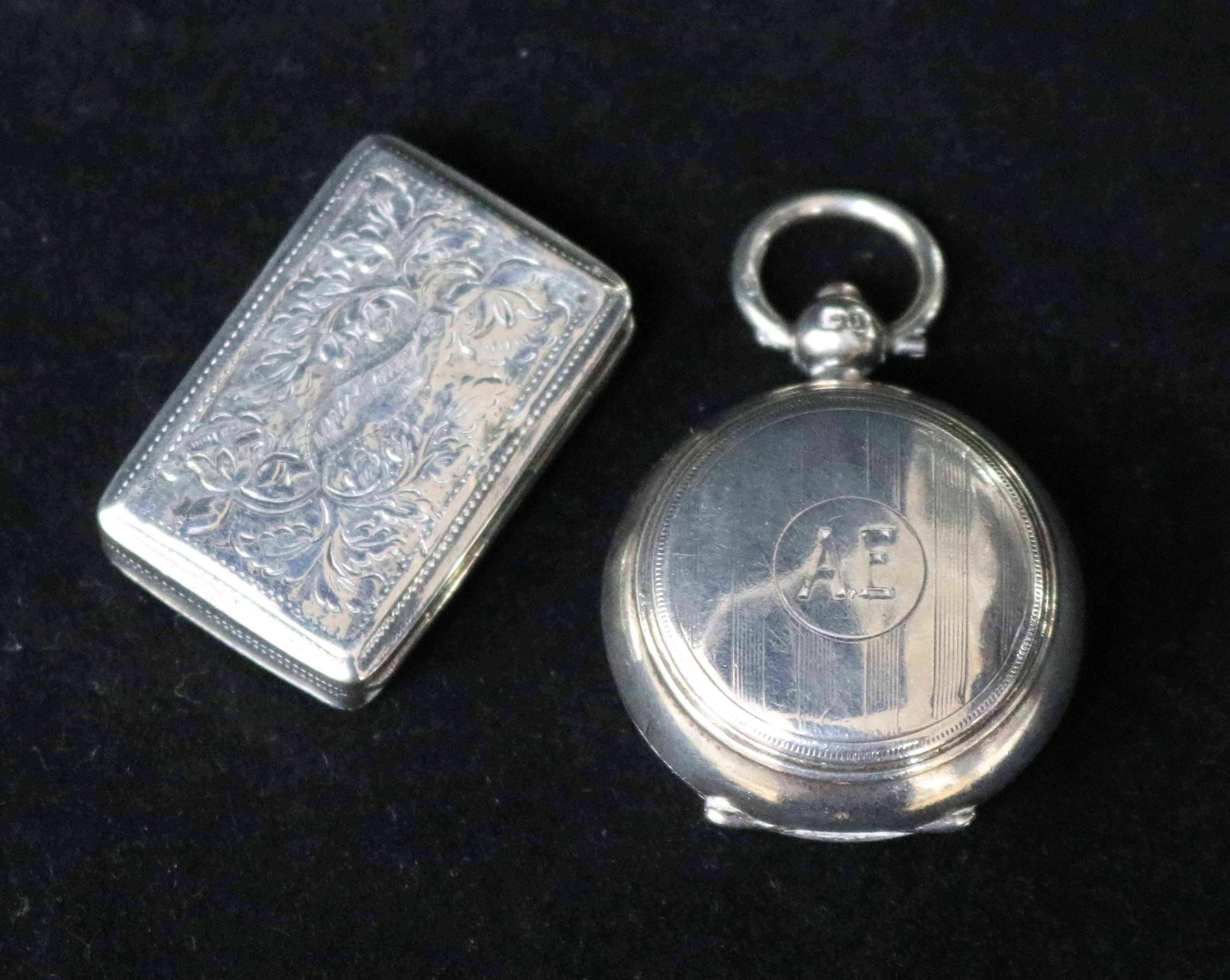 A George V silver sovereign case and a William IV silver vinaigrette.